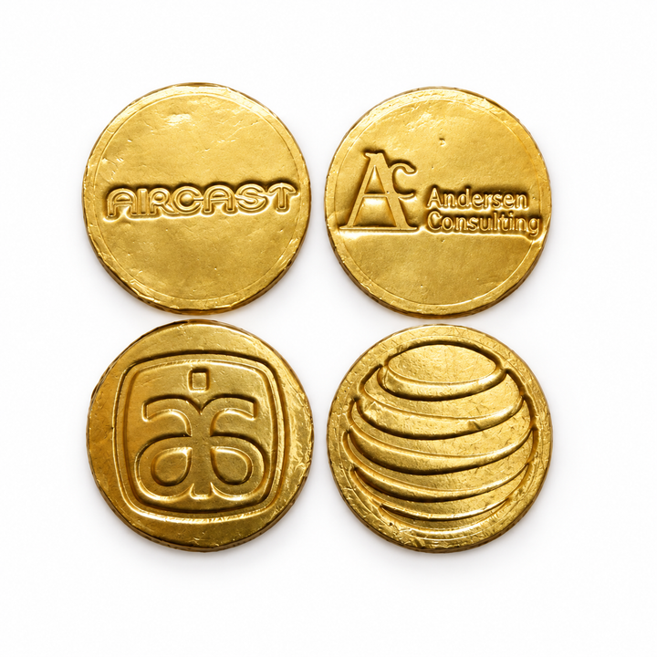 Four gold foil chocolate coins, each stamped with a different company logo