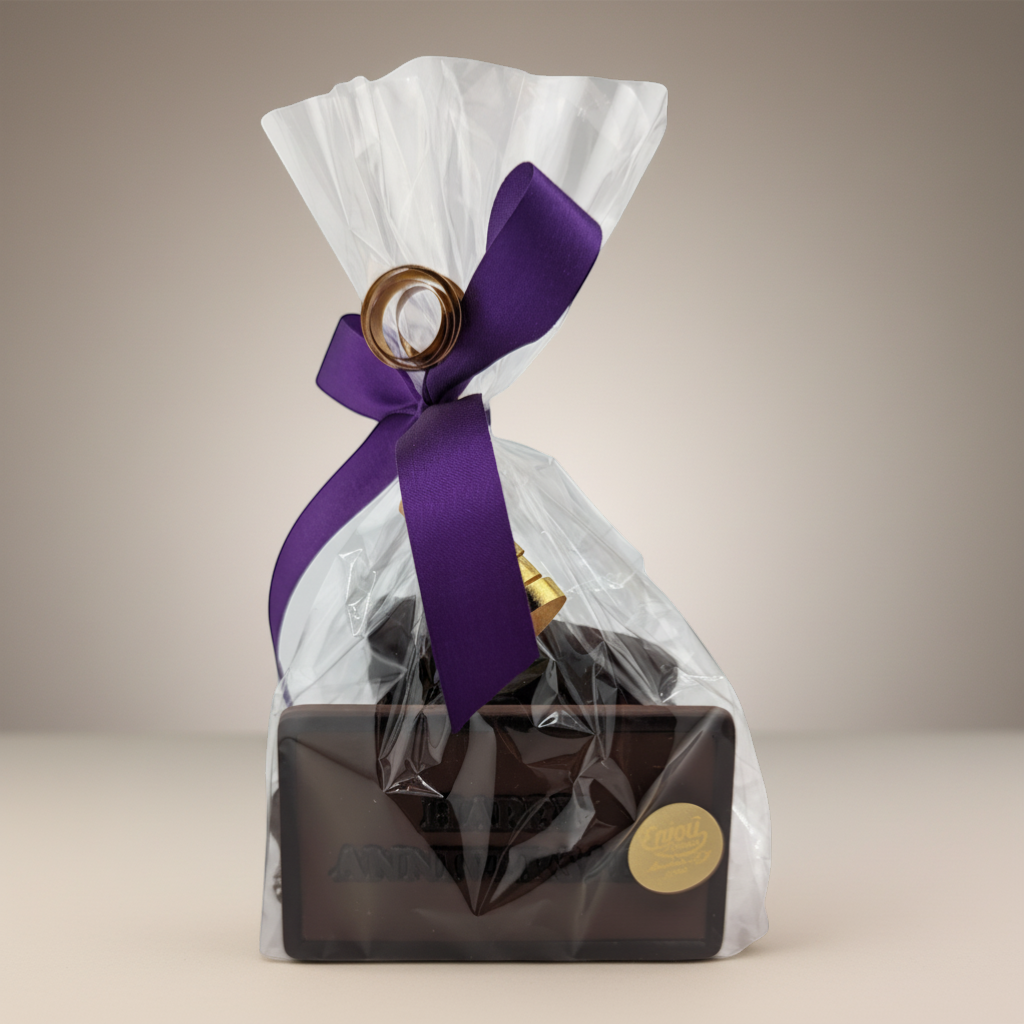 Enjou Chocolat Anniversary Package: chocolate bar, graham cracker, Oreos, and nonpareils in a clear gift bag with a purple ribbon.