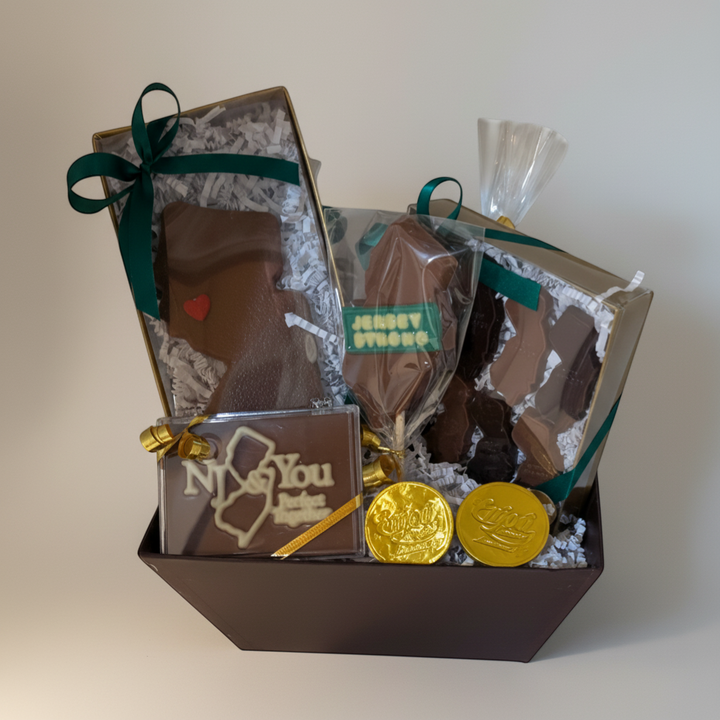 Enjou Chocolat New Jersey state-shaped chocolates, lolly, coins, and pretzels in a gift basket.
